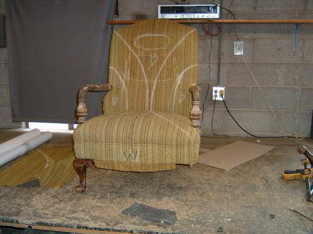 Brown chair before restoration - worn fabric and damaged upholstery